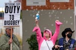 A demonstrator blows bubbles during a protest outside a U.S. Immigration and Customs Enforcement facility on Saturday, Oct. 11, 2025, in Portland, Ore.