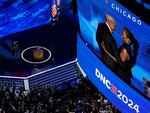 Former President Barack Obama hugs his wife Former first lady Michelle Obama during the Democratic National Convention Tuesday in Chicago.