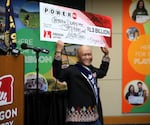 Powerball Lottery winner, Cheng 'Charlie' Saephan, celebrates his big win at the Oregon Lottery offices in Salem, Ore., on April 29, 2024.