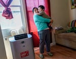 Juana Pascual Pascual holds her child Frankie Gaspar, 2, at their second-floor Portland apartment where they've lived for six years. She said her family suffered during last year’s heat dome with just bottled water to find relief. She received a free cooling/heating unit through the Portland Clean Energy Fund working with Verde.