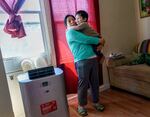 Juana Pascual Pascual holds her child Frankie Gaspar, 2, at their second-floor Portland apartment where they've lived for six years. She said her family suffered during last year’s heat dome with just bottled water to find relief. She received a free cooling/heating unit through the Portland Clean Energy Fund working with Verde.