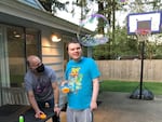 Andrew Simmons, right, blows bubbles with his father Bo last spring. Andrew, who's profoundly autistic and mostly non-verbal, lives in a supported living home in Snohomish County operated by Aacres WA, a troubled state contractor. Bo Simmons says conditions in the home over the past year have deteriorated to the point of being dangerous for Andrew and his housemates. 