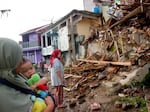 Residents inspect houses damaged by Monday's earthquake in Cianjur, West Java, Indonesia Tuesday, Nov. 22, 2022.
