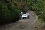 Multiple cars parked along a rural road in Forest Grove, Org., on Aug. 23, 2026, during a suspicious death investigation.