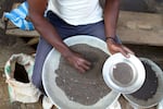 A Congolese miner sifts through ground rocks to separate out the cassiterite, the main ore that's processed into tin, in the town of Nyabibwe, eastern Congo, 2012.
