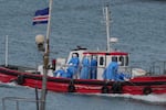 Health workers in protective gear arrive to evacuate patients from the MV Hondius cruise ship at a port in Praia, Cape Verde, Wednesday, May 6, 2026.