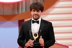 FILE - U.S. scientist Karl Deisseroth, professor of Departments of Bioengineering and Psychiatry at Stanford University, shows his trophy for "Life Sciences" field during the Japan Prize presentation ceremony Thursday, April 13, 2023, in Tokyo.