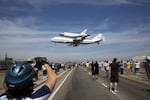 The space shuttle Endeavour, mounted atop a NASA 747 Shuttle Carrier Aircraft lands at Los Angeles International Airport, on Sept. 21, 2012.