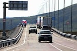 In this photo released by the Government of Primorsky Krai Region on Monday, Sept. 7, 2026, vehicles drive across the new bridge between Russia and North Korea named after the Soviet officer Yakov Novichenko, who is credited with saving North Korea's founding leader, Kim Il-sung, over the Tumannaya River in Primorsky Krai Region of Russia.