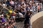 Cousins react as they watch the bareback competition on Friday.