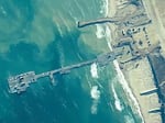 The image provided by U.S, Central Command, shows U.S. Army soldiers, U.S. Navy sailors and Israel Defense Forces placing the Trident Pier on the coast of Gaza Strip on Thursday.