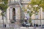 Police officers work by a basket lift used by thieves Sunday, Oct. 19, 2025 at the Louvre museum in Paris.