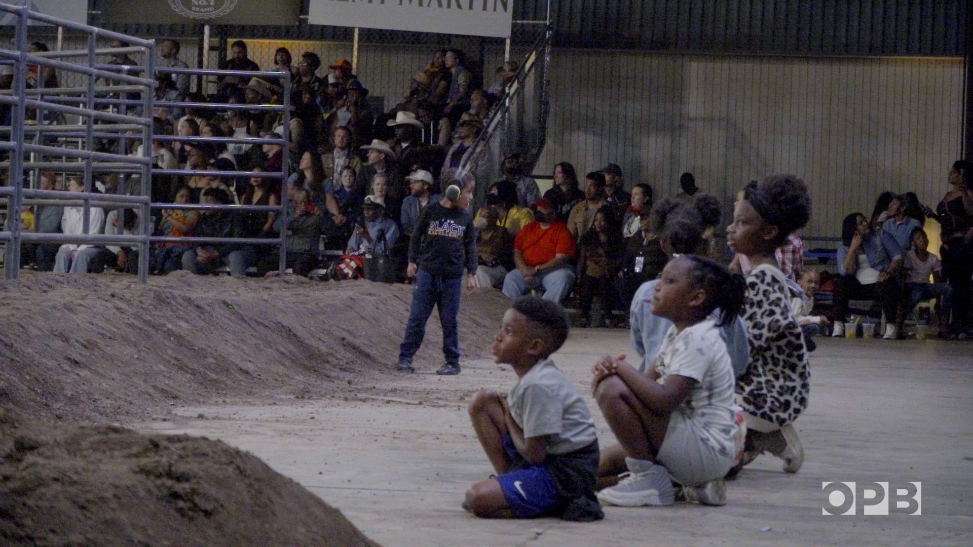 Young rodeo-goers watching at one end of the arena at Portland's first Eight Seconds Juneteenth Rodeo, June 17, 2023.