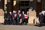 Former and current U.S. Secret Service agents assigned to the Carter detail, move the flag-draped casket of former President Jimmy Carter, at Phoebe Sumter Medical Center.