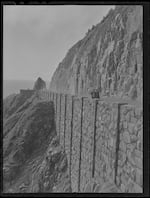 A photo from the Oregon Historical Society shows Highway 101 at Neahkahnie Mountain (OHS Research Library, Org. Lot 1284). The steep, rocky, remote terrain of the coast presented significant challenges while constructing the highway.