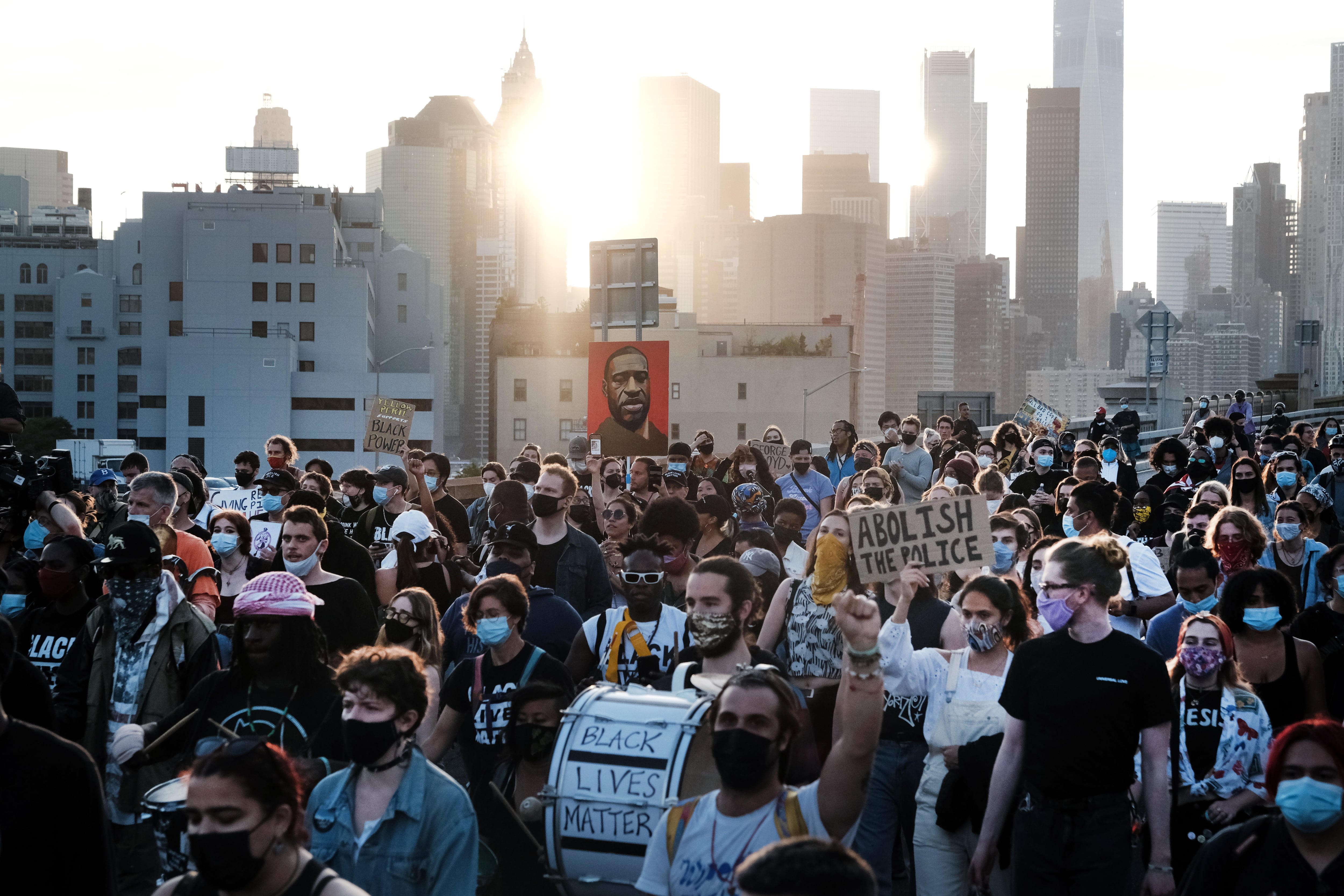 Black Lives Matter supporters and others march across the Brooklyn Bridge to honor George Floyd on the one year anniversary of his death on May 25, 2021 in New York City.