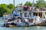 Boats anchored in the Willamette River near Ross Island appear to be abandoned, June 25, 2022. In June, the State Land Board directed the department to request $40 million in state general funds to create a state program to address the hundreds of commercial and recreational vessels littering Oregon’s waterways. If the request is approved, an estimated 175 recreational boats in the Portland metro area would be removed, but not until 2024 or 2025.