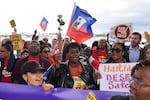 People chant during a rally in Fort Lauderdale, Fla., in support of the extension of Temporary Protected Status (TPS) for Haitian immigrants.