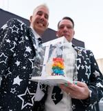 Mark Gallina, left, and Marx Phillips, right, hold a small wedding cake after signing their wedding certificate at “I Do at Darcelle” in Darcelle XV Plaza in Portland, Ore., on July 18, 2026.