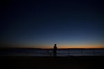 Eric Shalit watches the sunset during a bike ride on Tuesday, December 5, 2017, in West Seattle.