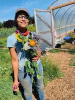 Mirabai Collins, co-founder and co-director of the Black Futures Farm in Southeast Portland, holds a bouquet of fresh flowers.