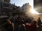 Palestinians inspect the destruction following an Israeli air strike on the Rafah refugee camp in the southern Gaza Strip on December 1, 2023.