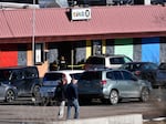 Law enforcement officers walk through the parking lot of Club Q, an LGBTQ nightclub, in Colorado Springs, Colo., on Sunday.