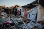Displaced Palestinians inspect the damage after an Israeli army strike on their tent camp in Deir al-Balah, Gaza Strip, Wednesday.