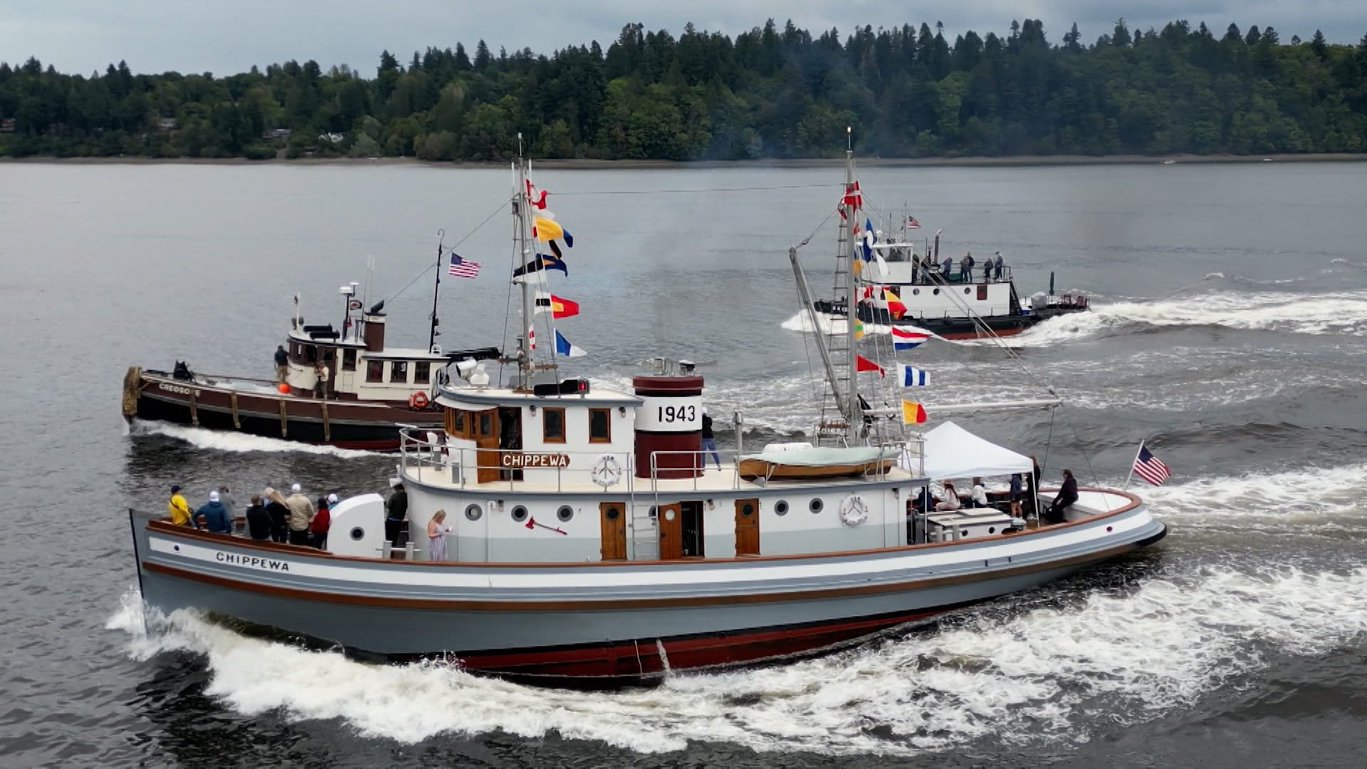 Three classic tugboats race during the annual Olympia Harbor Days festival in Budd Inlet near Olympia, Wash., in August 2023.