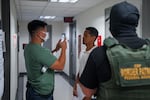 An Immigration and Customs Enforcement (ICE) agent uses facial recognition software to confirm an asylum seeker's identity prior to an immigration hearing on July 30, 2025, in New York. In addition, DHS is expanding its use of iris scanners to help quickly identify undocumented immigrants.