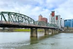 The Hawthorne Bridge, built in 1910, is the oldest vertical lift bridge still in operation in the United States. It has to be lifted every eight hours to keep the cables greased. Multnomah County Bridge Operators watch over it, 24 hours a day, from the control room.