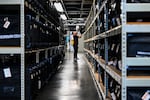 An election office worker moves bags of election supplies at the Robert L. Gilder Elections Service Center in Tampa, Florida, on November 2, 2024.