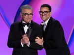 Hosts Eugene Levy and Dan Levy speak during the 76th Primetime Emmy Awards on Sunday at the Peacock Theater in Los Angeles.