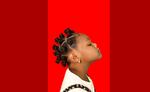 A hair model poses with Bantu Knots for an exhibit at Eugene's 2023 Juneteenth celebration themed "Black Hair Matters."