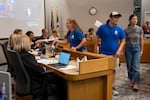 Portland Association of Teachers members give petitions to Portland Public School Board members.