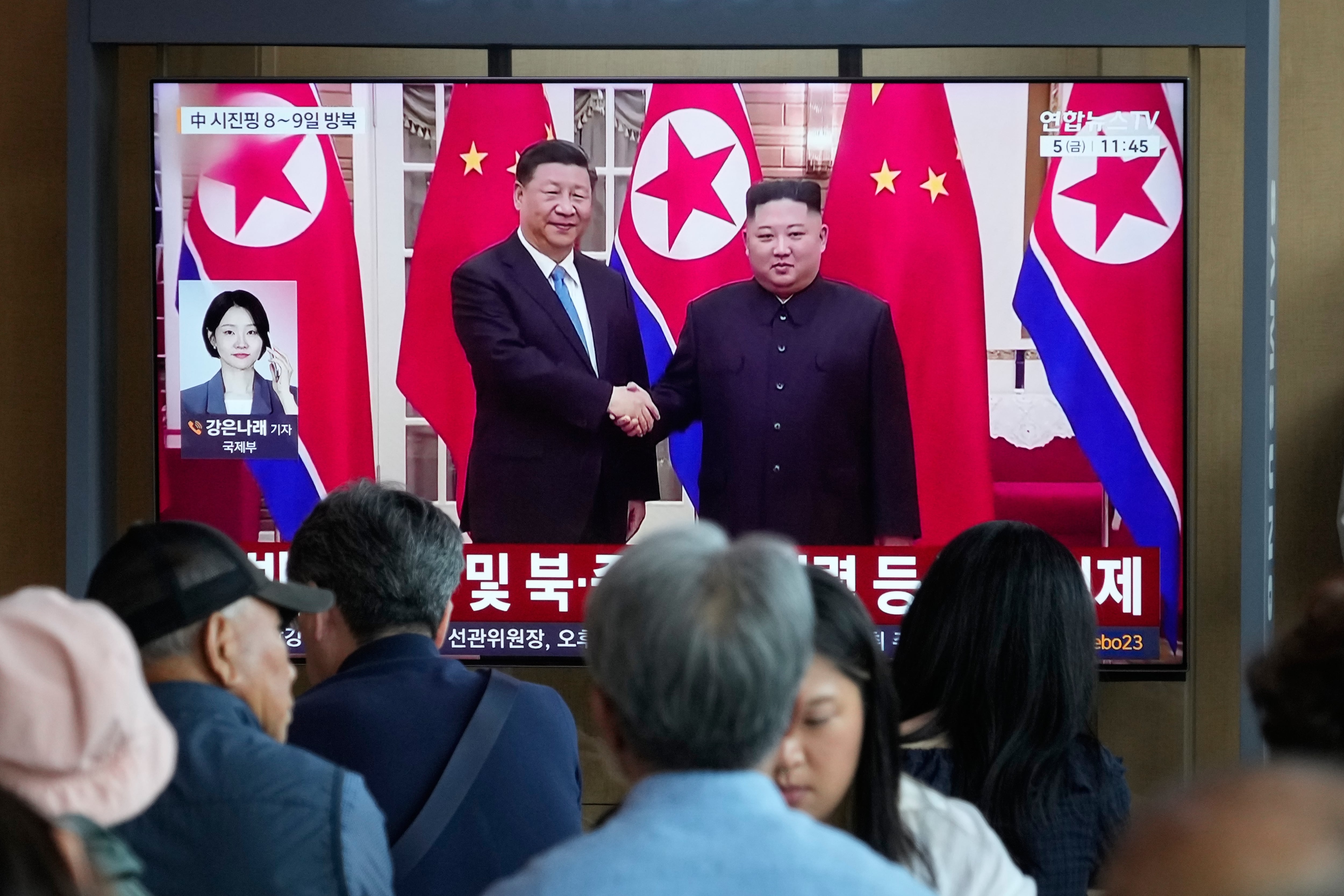 People watch a TV screen showing a file image of North Korean leader Kim Jong Un, right, and Chinese President Xi Jinping, at the Seoul Railway Station in Seoul, South Korea, Friday, June 5, 2026.