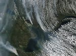 Wildfires outside of Yellowknife, the capital of Canada's Northwest Territories, as seen from space on Tuesday. As of Thursday the fires are less than 10 miles outside of the city.