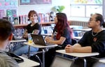 David Douglas High School students (left to right) Liana Kucher, Mel Borbon Tabarez, and Kenai Robertson discuss their experiences working in classrooms across the district as part of an Intro to Education class at the school. Some of the juniors and seniors in this class want to become teachers and the class offers an opportunity to try it out before they even graduate high school.