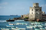 Somali fishing boats are seen in the old port and traditional lighthouse at Lido beach on Nov. 11, 2022 in Mogadishu, Somalia.