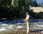 Jeff Thomas fishes for bull trout at the base of Clear Creek Dam. He's hoping to catch the fish to help move them around the dam.