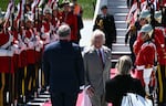 Britain's King Charles III is greeted by an honor guard after arriving at Macdonald-Cartier International Airport in Ottawa, Canada, on Monday. Britain's King Charles III is heading to Canada for a brief but "impactful" visit, at a time when President Donald Trump is floating the idea of making his northern neighbour the 51st US state. The 76-year-old monarch, who is also Canada's head of state as part of the Commonwealth, has never publicly commented on the ambitions of the US president, a noted admirer of the royal family. (Photo by Ben STANSALL / AFP) (Photo by BEN STANSALL/AFP via Getty Images)