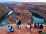 Visitors view the dramatic bend in the Colorado River at the popular Horseshoe Bend in Glen Canyon National Recreation Area, in Page, Ariz., on Sept. 9, 2011.