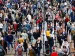 Travelers wait in line before passing through a security checkpoint at Denver International Airport on December 28, 2022 in Denver, Colorado.