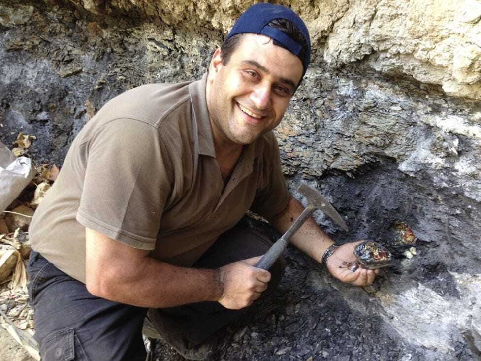 Danny Azar holds a large amber specimen, found in the area of Wadi Jezzine in 2015. 