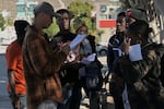 Haitian migrants shows their paperwork to Mexican immigration officials to proceed with their CBP One asylum appointments at the Chaparral pedestrian border in Tijuana, Mexico to cross to the U.S. last Thursday.