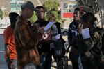 Haitian migrants shows their paperwork to Mexican immigration officials to proceed with their CBP One asylum appointments at the Chaparral pedestrian border in Tijuana, Mexico to cross to the U.S. last Thursday.