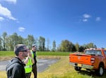 Next to the Portland International Airport runway, three members of the wildlife team monitor radio-controlled canons used to haze birds.
