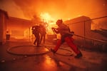 Firefighters protect a structure as the Eaton Fire advances Wednesday, Jan. 8, 2025 in Altadena, Calif.