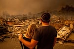 Wednesday, Jan. 8: Megan Mantia, left, and her boyfriend, Thomas, return to Mantia's fire-damaged home after the Eaton Fire swept through Altadena, Calif.