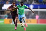 Seattle Sounders defender Nouhou Tolo, right, holds Portland Timbers forward Antony Alves Santos, left, behind him as he moves the ball during the second half of an MLS soccer match Saturday, Oct. 19, 2024, in Seattle. The Sounders and the Timbers played to a 1-1 draw.